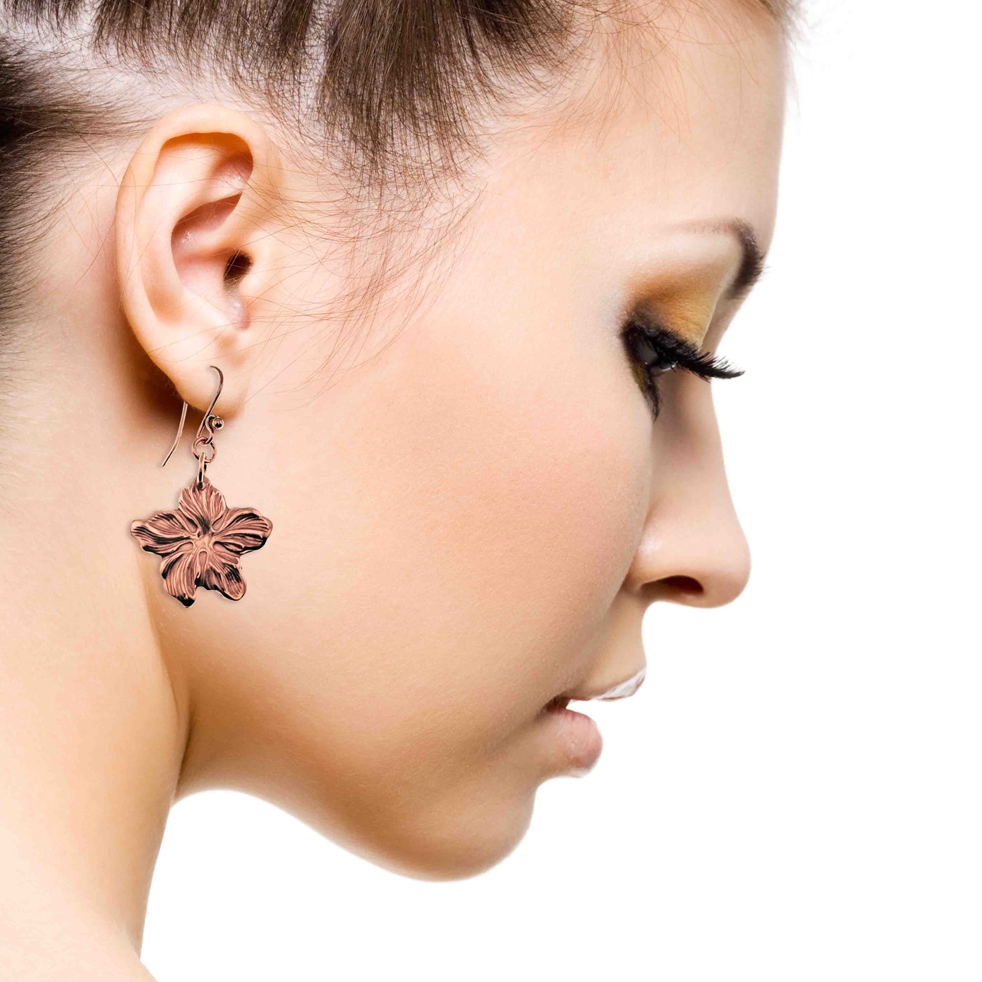 An Elegant Woman Wearing Copper Hibiscus Flower Dangle Earrings
