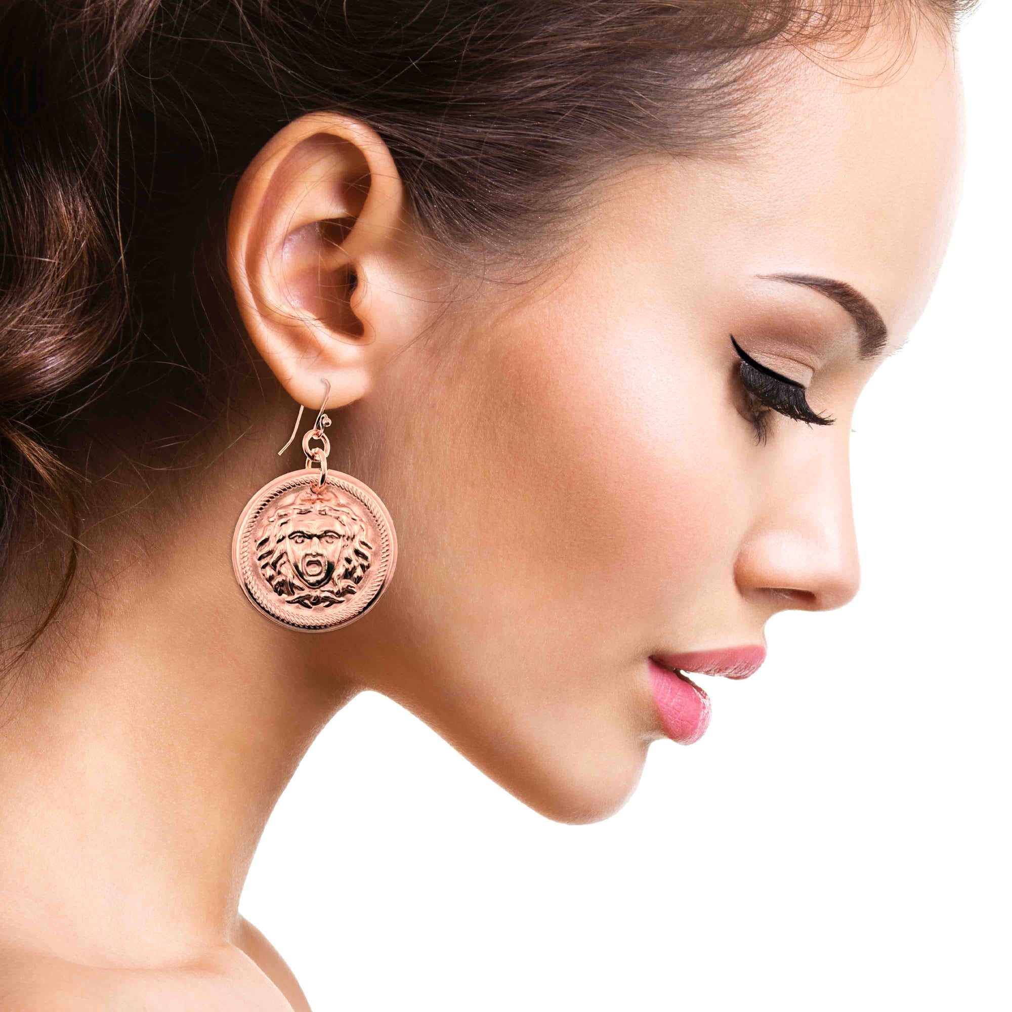 Close-up of a woman wearing Copper Medusa Disc Drop Earrings 