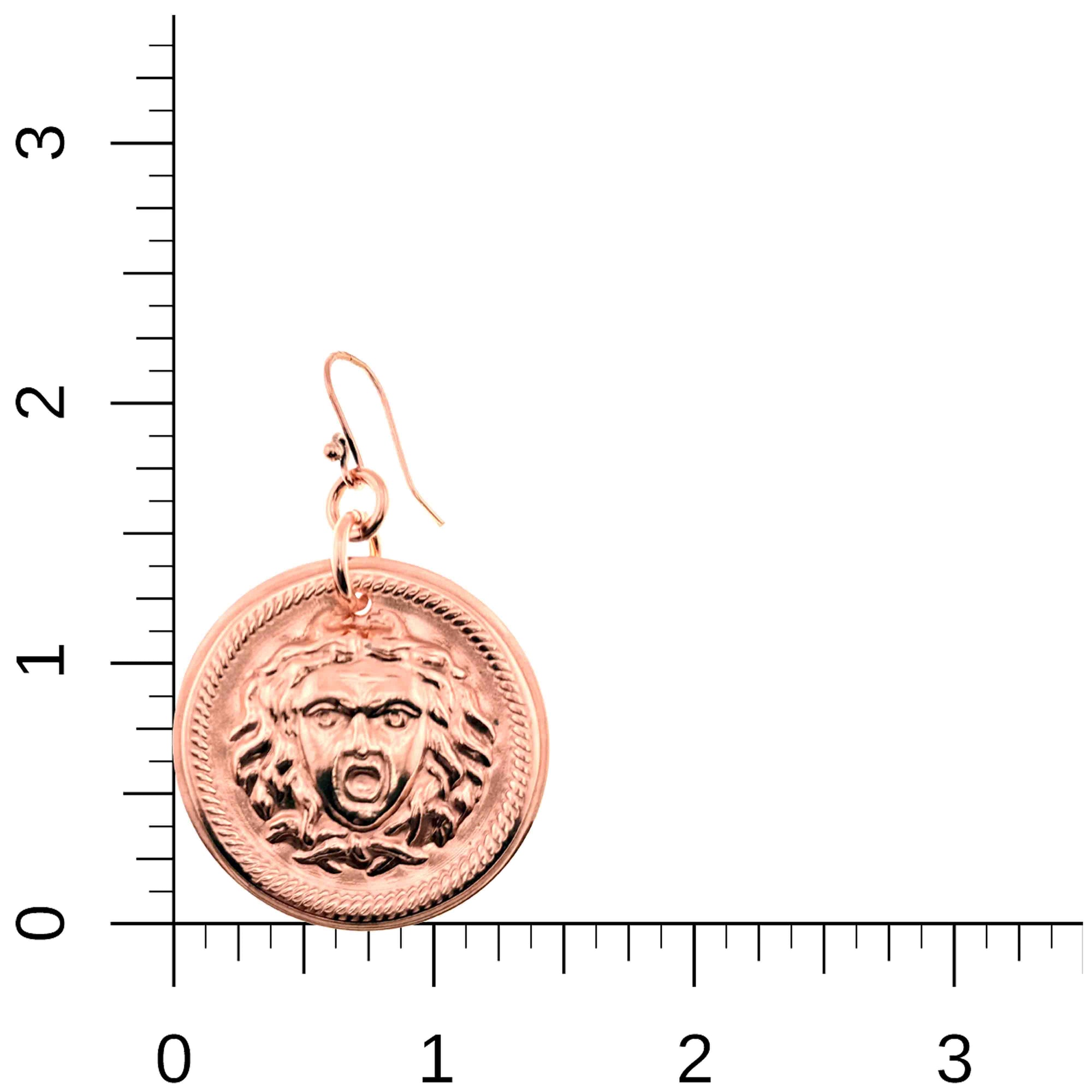 Copper Medusa Disc Drop Earrings on a ruler for scale