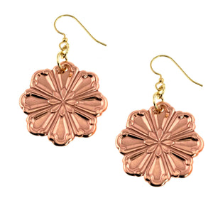 1 of 7: Pair of handcrafted copper flower dangle earrings with polished, die struck petal detailing. Each earring features a eight petal bloom design with raised texture and a warm rosy copper shine. The flowers hang from small gold tone jump rings and brass French hook ear wires. Feminine floral style, approximately 2 inches long, shown against a light neutral background.