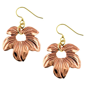 1 of 7: Handcrafted copper petal blossom dangle earrings with polished die struck floral detailing and open center design, suspended from brass French ear wires on a clean white background.