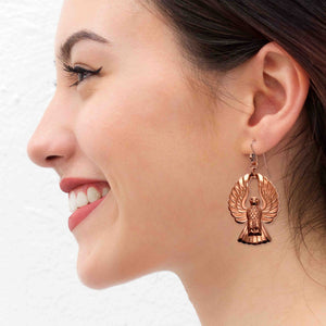 2 of 7: A Smiling Woman Wearing Copper Phoenix Firebird Drop Earrings
