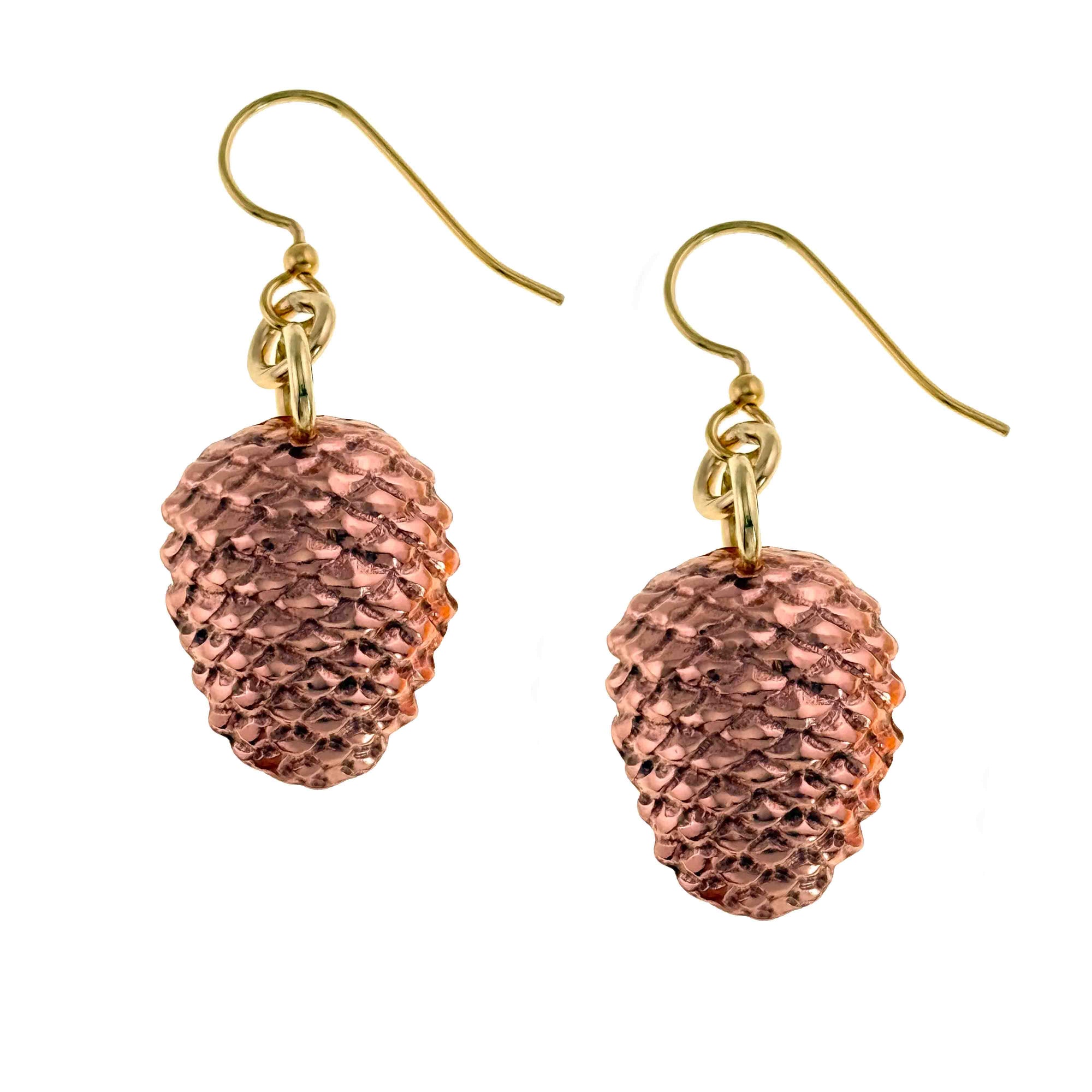 Copper pinecone-shaped earrings with gold hooks on a white background