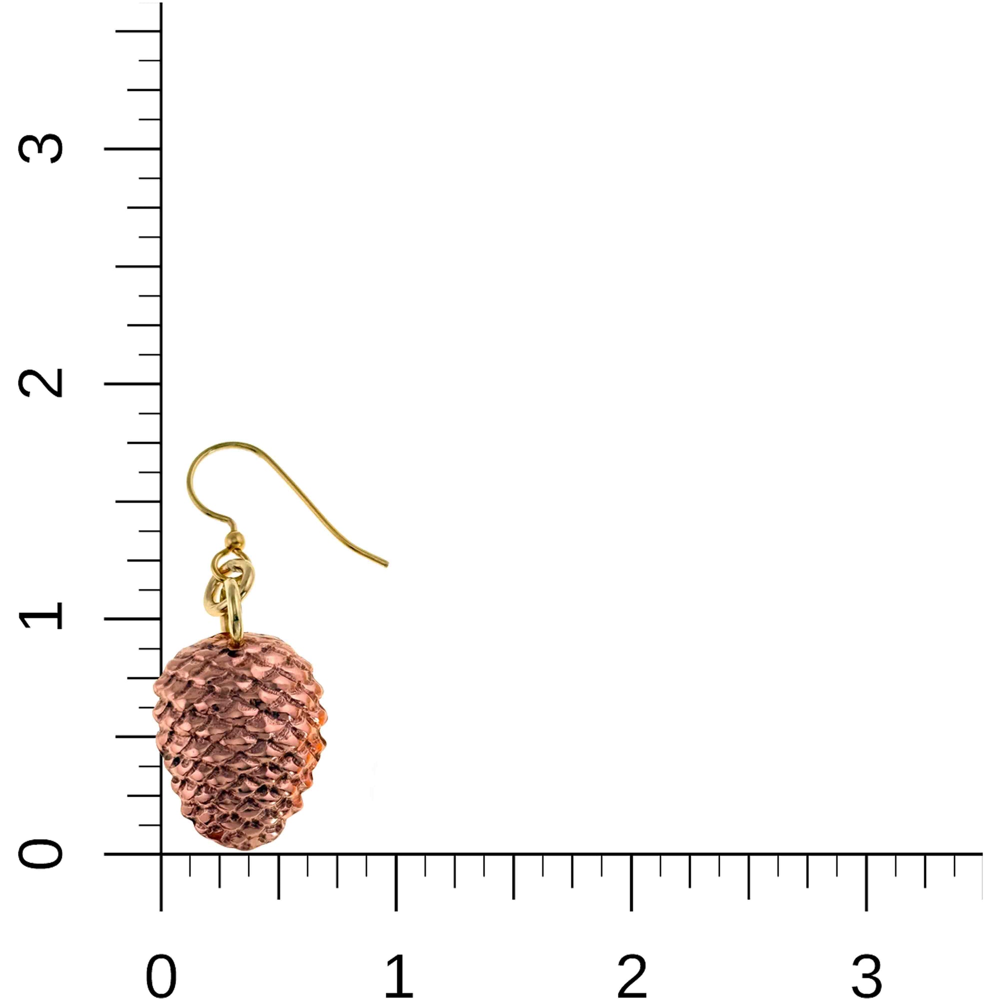 Pine cone-shaped earring next to a ruler for scale on a white background