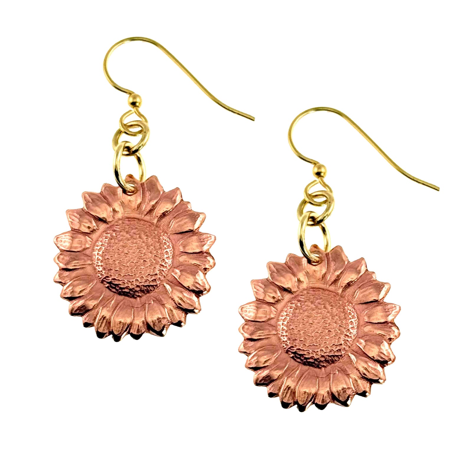 Handcrafted copper sunflower dangle earrings with detailed die struck petals and textured centers. The warm raw copper medallions hang from gold tone brass French ear wires, creating a soft contrast of color. Feminine floral design with a polished finish, lightweight and ideal for everyday wear or spring and summer outfits.