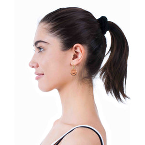 6 of 7: Side profile of a woman with dark hair in a ponytail wearing copper sunflower dangle earrings. The small floral medallion features detailed petals and a textured center, hanging from a gold tone brass French hook. Set against a clean light background, the earrings add a soft, feminine touch to an everyday look.