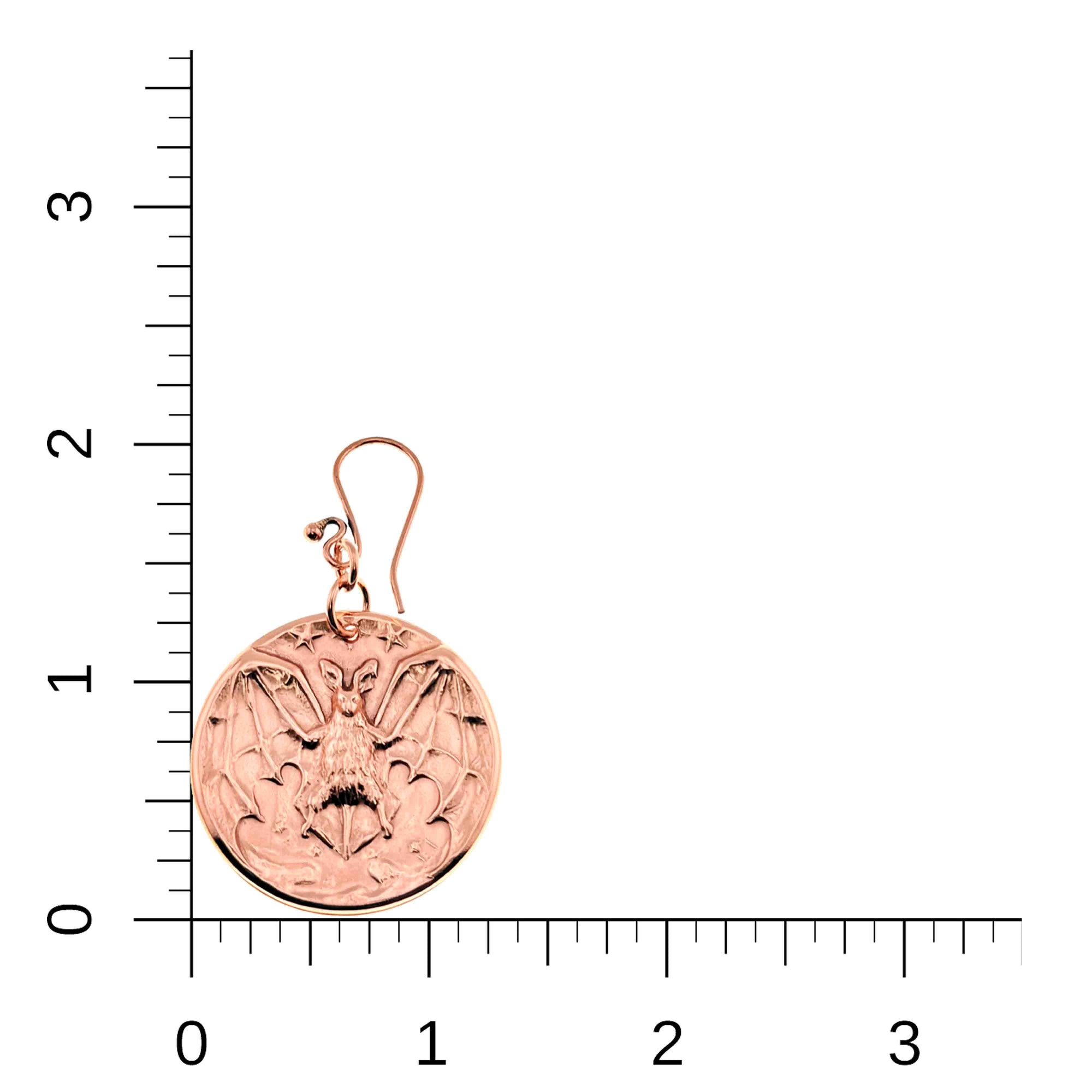 Copper Vampire Bat Disc Dangle Earrings on a white background with measurement scale