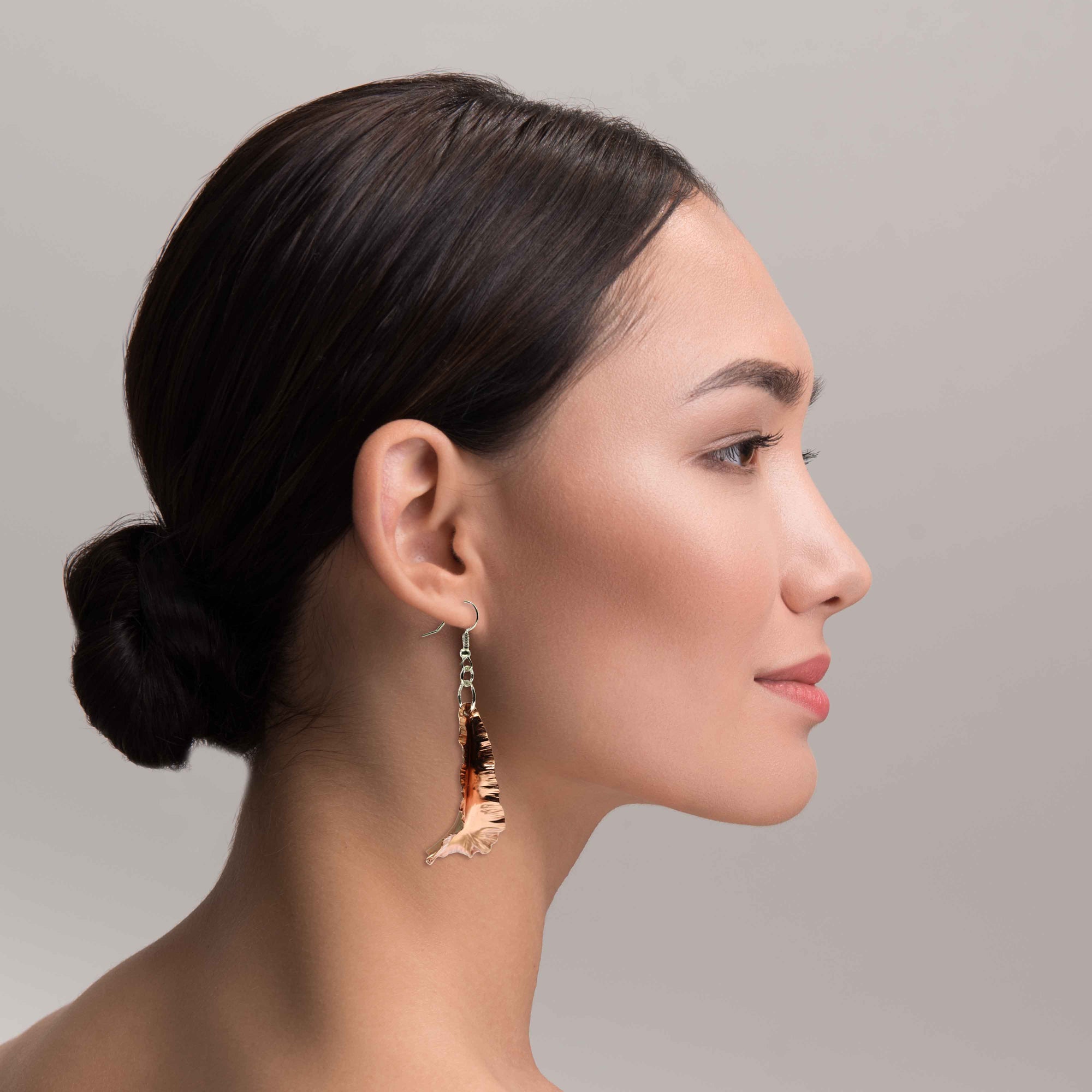 An Elegant Woman Wearing Copper Fold Formed Leaf Dangle Earrings