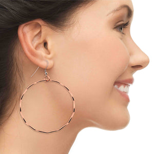 6 of 8: A Chic Woman Smiling Wearing Corrugated Copper Hoop Earrings