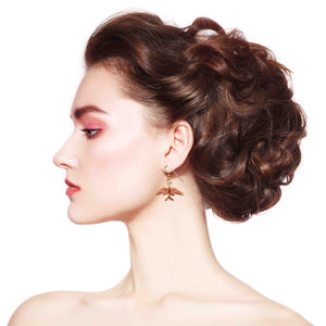 4 of 6: A Stunning Woman Wearing Dainty Copper Swallow Earrings
