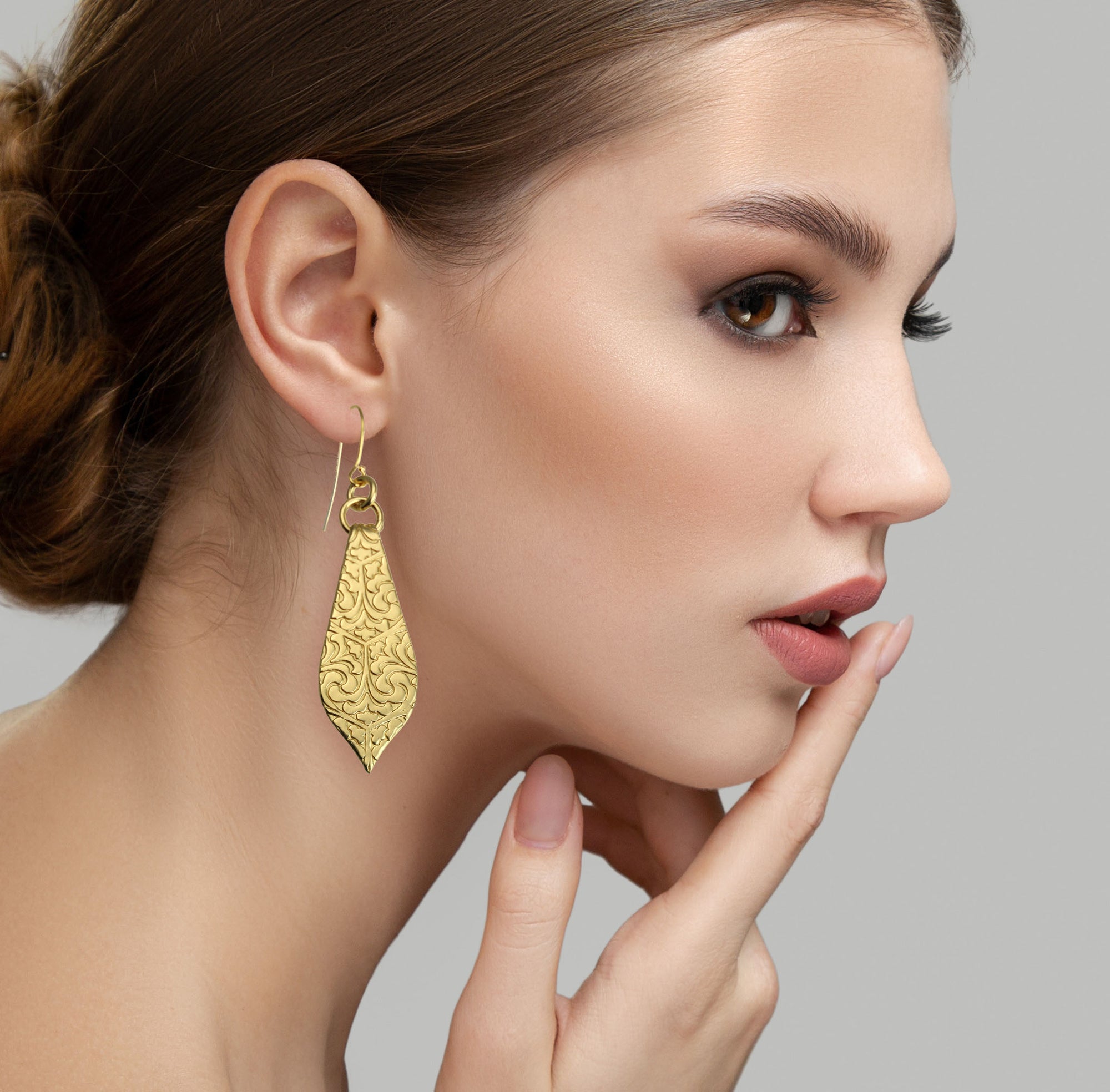 Sophisticated Female Model Wearing Damask Embossed Brass Nu Gold Marrakesh Teardrop Earrings