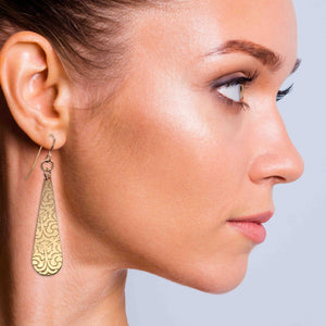 6 of 7: Chic Woman Wearing Damask Embossed Bronze Long Teardrop Earrings