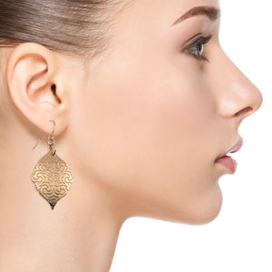 6 of 7: A Stylish Woman Wearing Damask Embossed Bronze Moroccan Drop Earrings