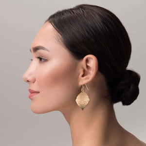 4 of 7: A Chic Woman Wearing Damask Embossed Bronze Moroccan Drop Earrings