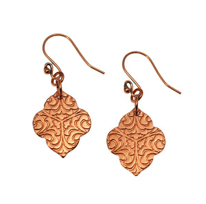 1 of 7: A Pair of Damask Embossed Copper Quatrefoil Drop Earrings on a White Background
