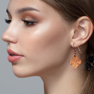 2 of 7: Stunning Woman Wearing Damask Embossed Copper Quatrefoil Drop Earrings