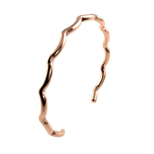 3 of 9: Product image of a slim open cuff bracelet in polished copper on a white background. The bracelet has a warm rose copper tone, a narrow band, and softly faceted wavy edges that create an organic scalloped shape. It is shown upright at a slight angle, with the open ends visible and the reflective finish highlighting its handcrafted look.