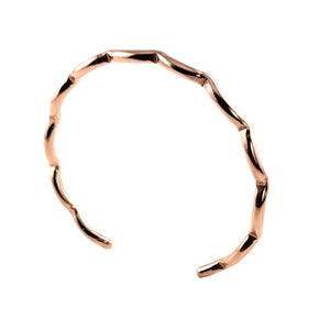 1 of 9: Handmade faceted copper edge cuff bracelet shown on a light gray background. The slim open cuff has a polished rose copper tone with softly scalloped, wavy edges and an organic faceted shape. The bracelet is photographed upright at a slight angle, highlighting its smooth reflective finish and narrow minimalist design.