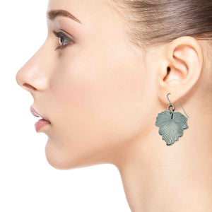 2 of 7: Close-up of a woman wearing Grape Leaf Aluminum Dangle Earrings on a white background