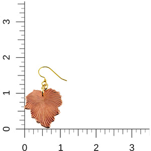 5 of 7: A single handcrafted copper grape leaf dangle earring with a brass French hook is displayed against a white background with a measurement grid. The grid shows the earring's size, approximately 1 ¾ inches in length and 1 inch in width. The leaf features fine veining detail and a warm, polished copper finish.