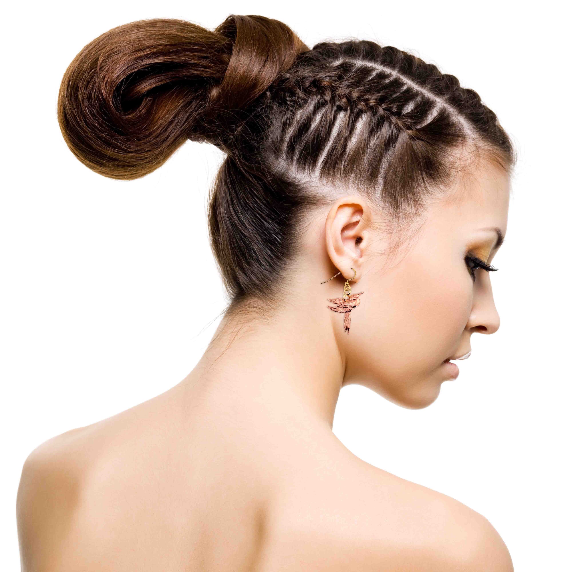 Woman with braided hairstyle on a white background wearing Great Blue Heron Copper Dangle Earring