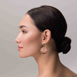 2 of 7: A Chic Woman Wearing Green Man Forest Medallion Disc Earrings