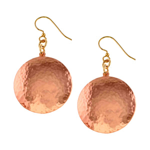 1 of 7: Pair of Hammered Copper Disc Earrings displayed on a clean white background. Each earring features a round hand hammered copper disc with a bright polished surface, suspended from a brass French ear wire.