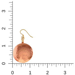 5 of 7: Hammered copper disc earring shown beside an inch ruler for scale. The earring measures about 2 inches long and 1 1/8 inches wide, with a round polished copper disc, hand hammered texture, and brass French ear wire.