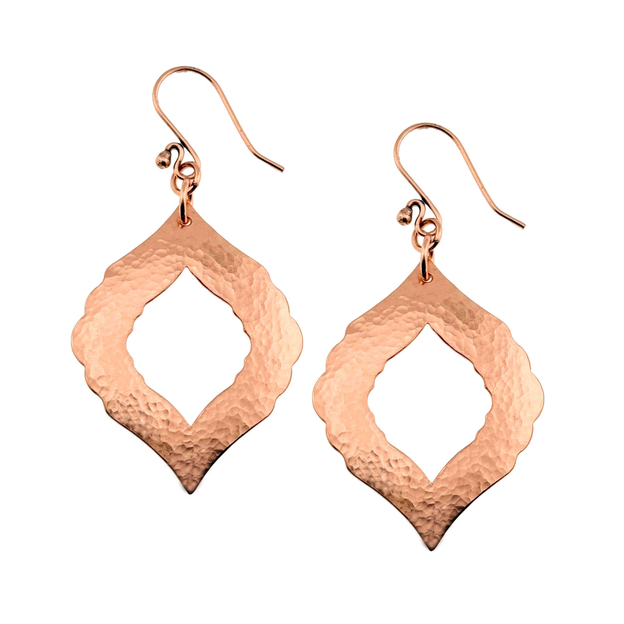 A Pair of Hammered Copper Pierced Moroccan Drop Earrings on a White Background
