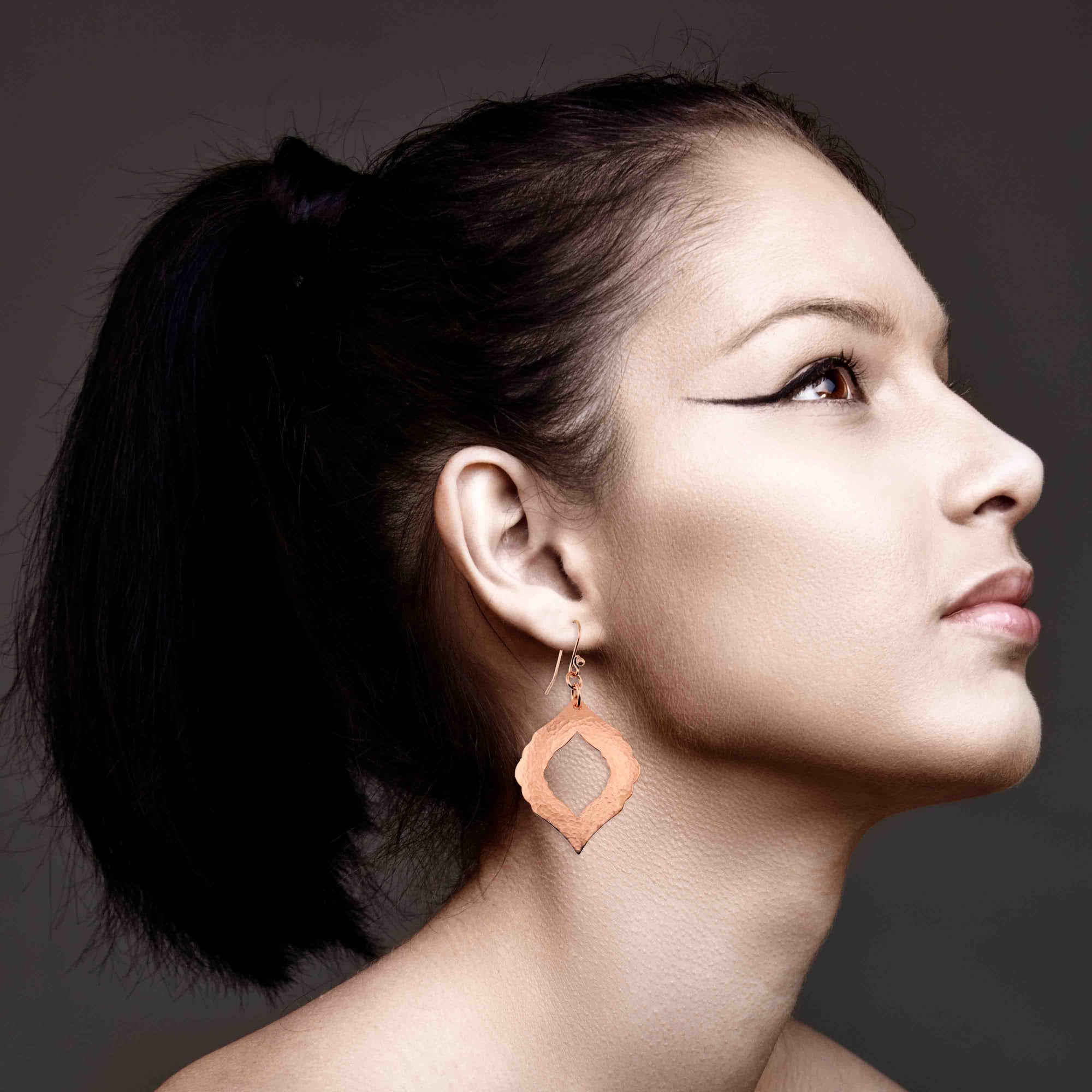 An Elegant Woman Wearing Hammered Copper Pierced Moroccan Drop Earrings