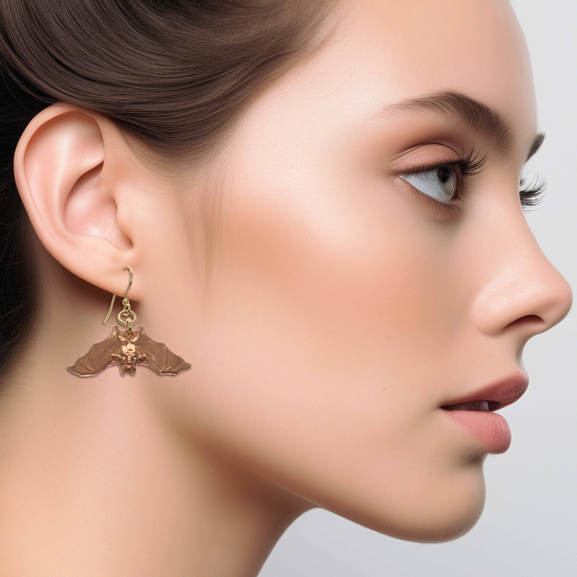 Stylish Woman Wearing Hanging Bat Copper Dangle Earrings