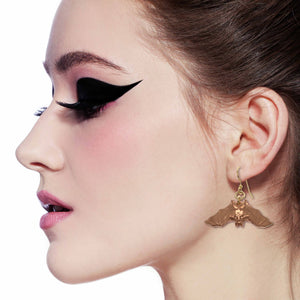 2 of 7: Gothic Woman Wearing Hanging Bat Copper Dangle Earrings