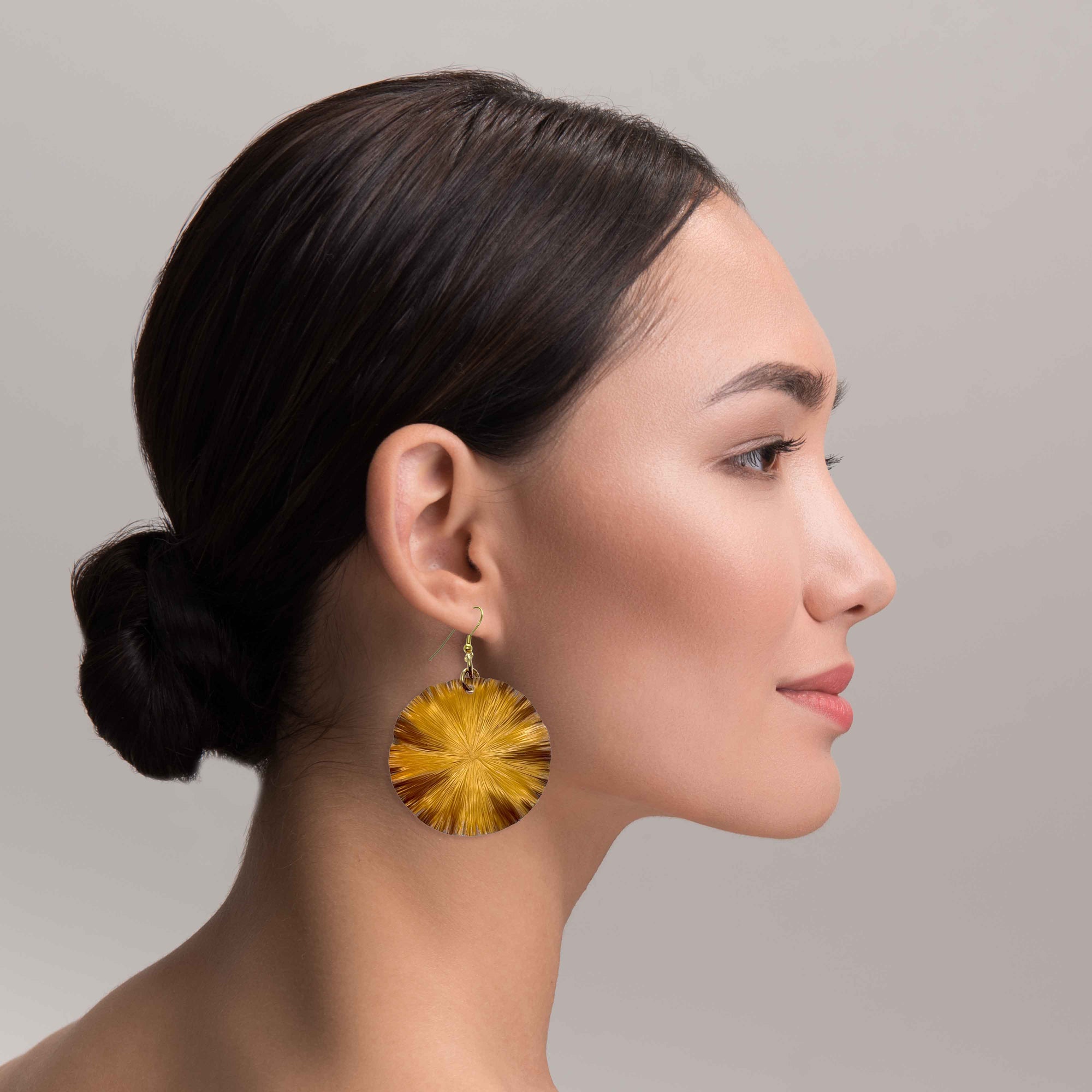A Fashionable Woman Wearing Large Light Orange Anodized Lily Pad Drop Earrings