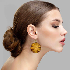 5 of 7: A Chic Woman Wearing Large Light Orange Anodized Lily Pad Drop Earrings