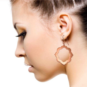 4 of 7: An Elegant Woman Wearing Large Pierced Hammered Copper Arabesque Flower Earrings