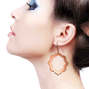 6 of 7: A Stunning Woman Wearing Large Pierced Hammered Copper Arabesque Flower Earrings