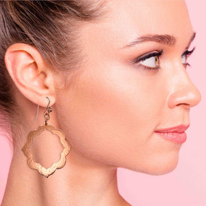 2 of 7: A Fashionable Woman Wearing Large Pierced Hammered Copper Arabesque Flower Earrings