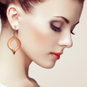 6 of 7: A Stylish Woman with Red hair Wearing Large Pierced Hammered Copper Marrakesh Earrings
