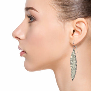 6 of 7: Fashionable Woman Wearing Long Feather Aluminum Drop Earrings 