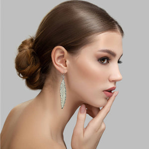 2 of 7: Elegant Woman Wearing Long Feather Aluminum Drop Earrings 