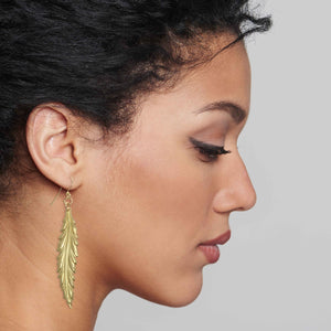 6 of 7: Stylish Woman Wearing Long Feather Brass Nu Gold Drop Earrings