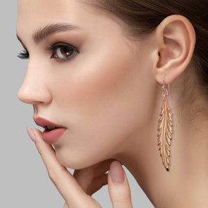 2 of 7: Elegant Woman Wearing Long Feather Copper Drop Earrings