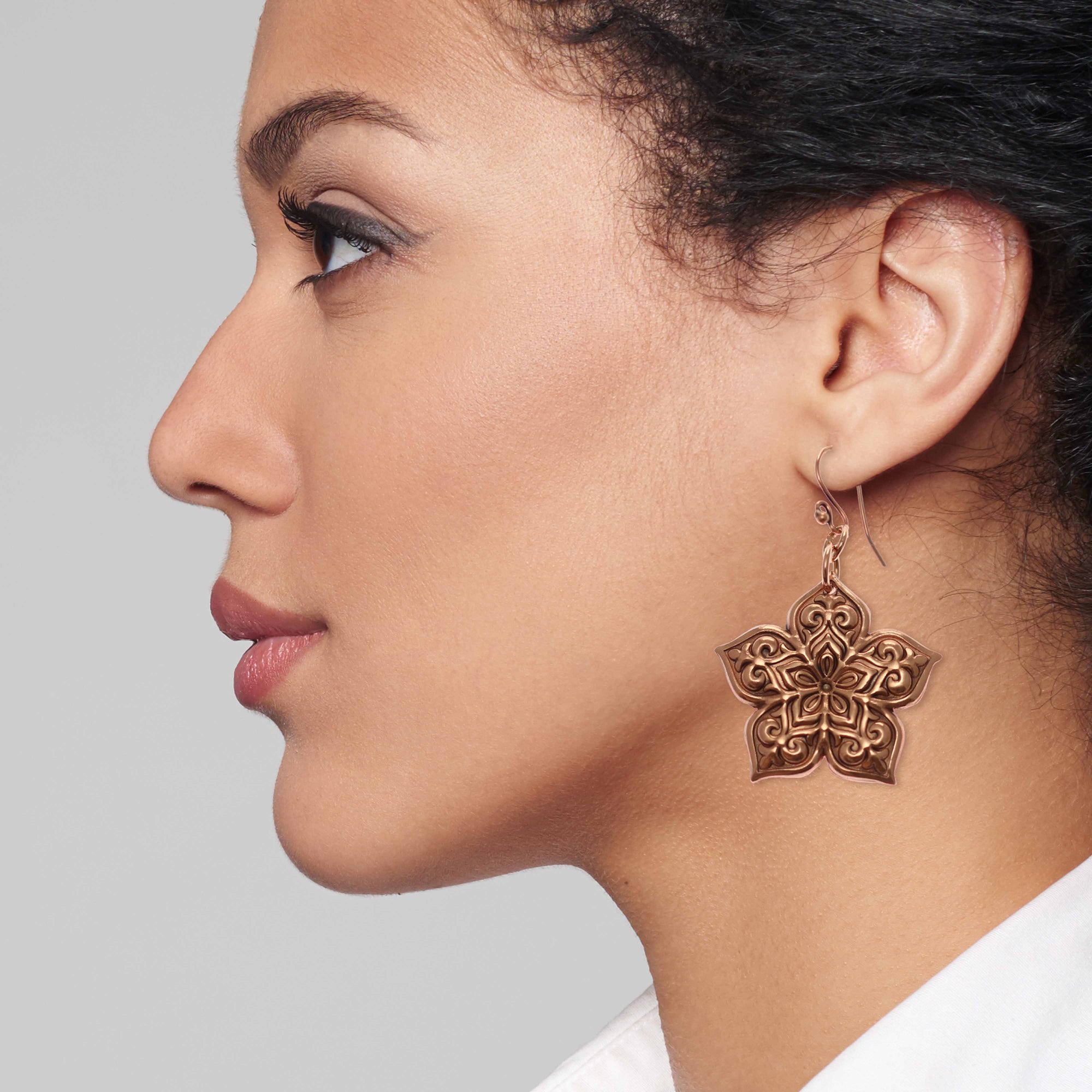 Elegant Woman Wearing Starflower Mandala Copper Drop Earrings