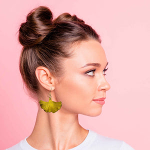 6 of 8: A Fashionable Woman in  a White T Wearing Medium Canary Yellow Anodized Ginkgo Leaf Earrings