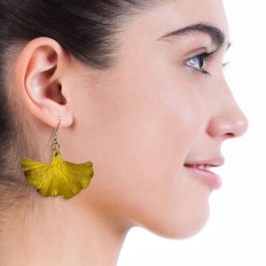 8 of 8: A Smiling Woman Wearing Medium Canary Yellow Anodized Ginkgo Leaf Earrings