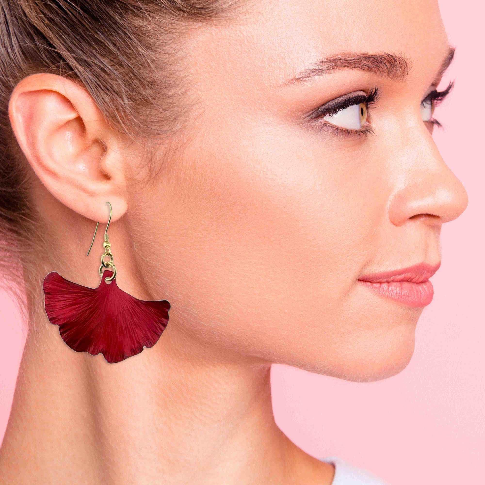 A Stunning Woman Wearing Medium Candy Apple Red Anodized Aluminum Ginkgo Leaf Earrings