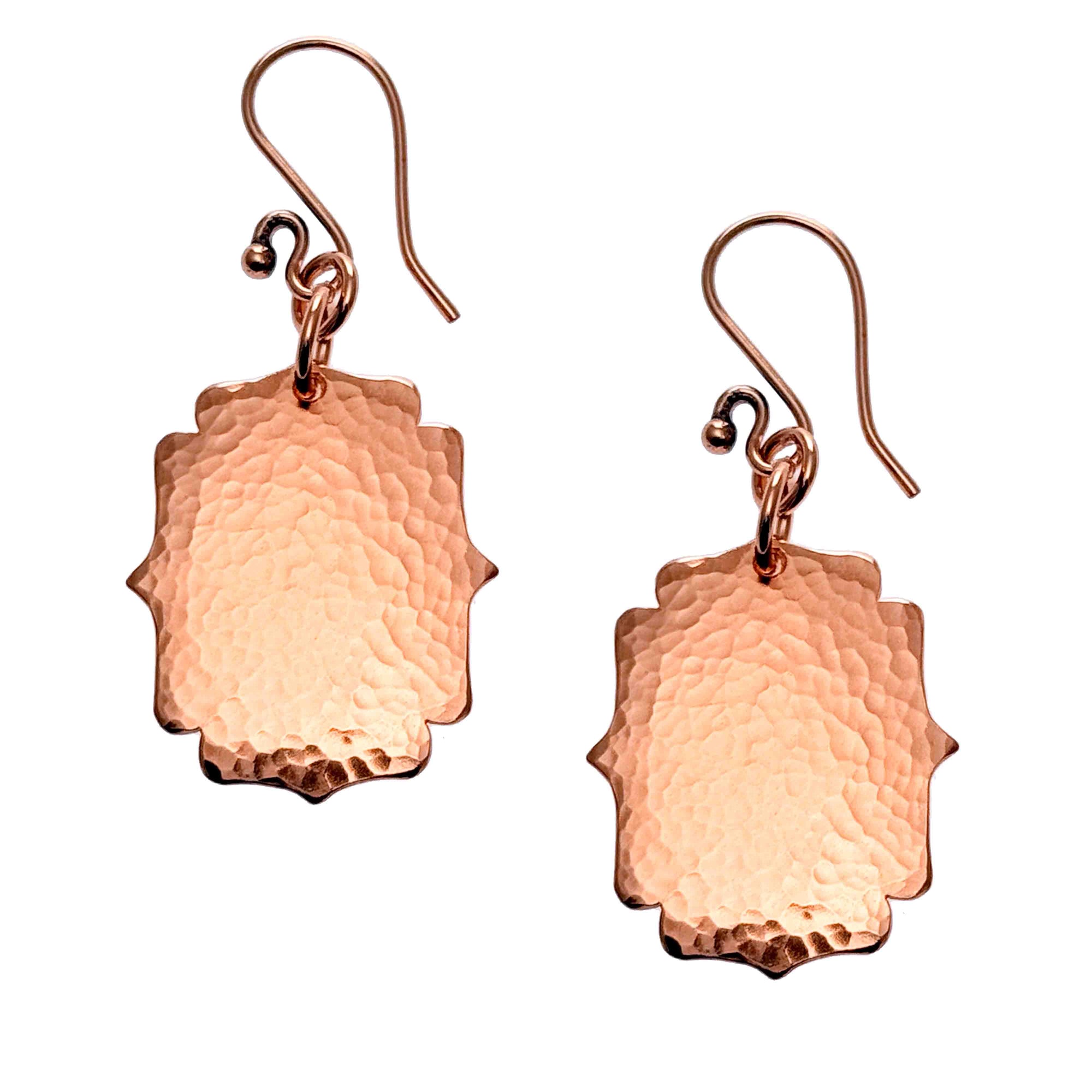 A Pair of Medium Hammered Copper Arabesque Shield Earrings on a White Background