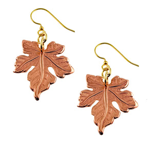 1 of 7: Medium Maple Leaf Copper Dangle Earrings with gold hooks on a white background