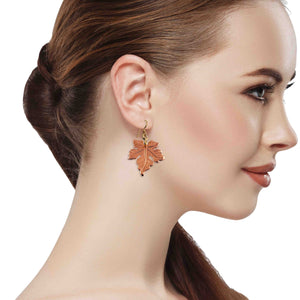2 of 7: Close-up of a woman wearing Medium Maple Leaf Copper Dangle Earrings on a white background