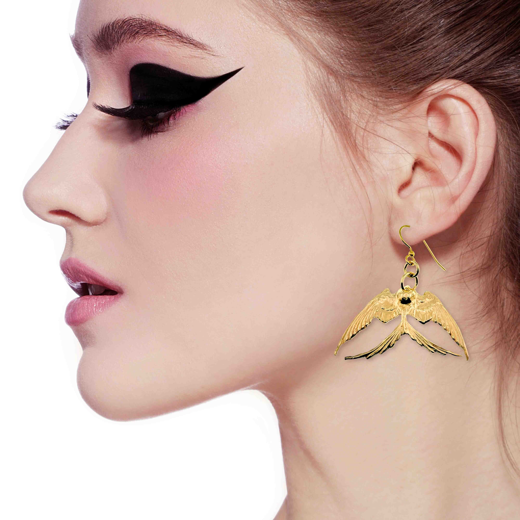 A Elegant Woman Wearing Medium Nu Gold Brass Swallow Earrings 